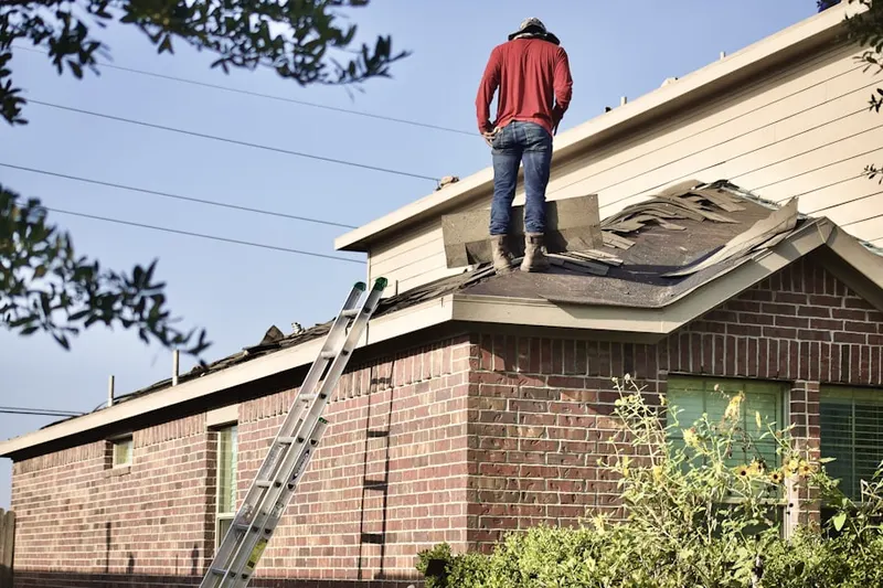 Professional roofer working on a residential roof in Alpine